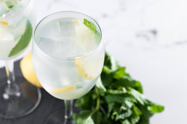 Hugo Cocktail, Lemon, Mint ve Ice in a Wine Glass ile mermer arka planda. Boşluğu kopyala