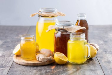 Ahşap masada renkli Kombucha Kavanozları ve Şişe