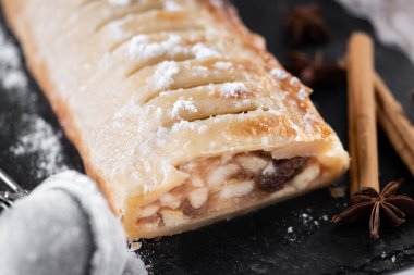Homemade apple strudel on white marble background. Close up