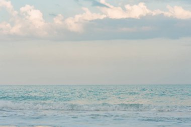 Marine nature. A small wave on the sea and a sky with clouds.