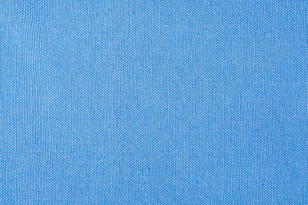 Blue background. Light blue fabric as a background macro photo.