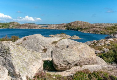 Walking path along the fjord on Skernoya island in southern norway clipart