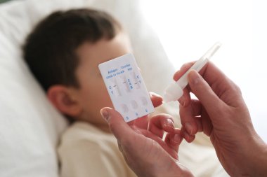 A little boy is sick, a combo antigen test (covid-19, flu a b, RSV) is needed for proper diagnosis.