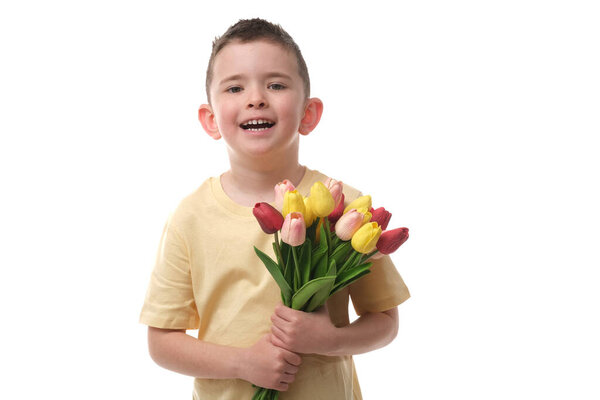 Cute baby boy with bouquet of tulips on isolated white background.