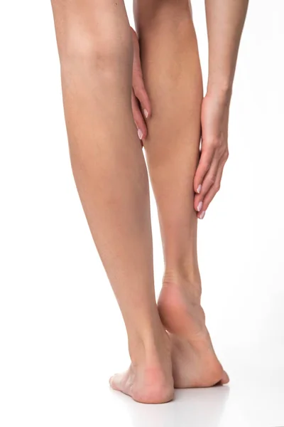 stock image Slim female legs on isolated white background.