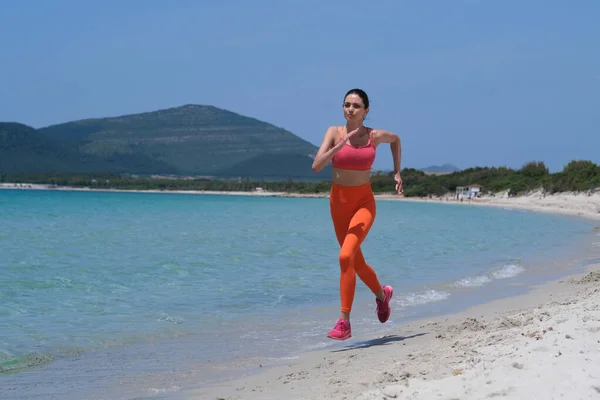 Μια Όμορφη Μελαχρινή Τρέχει Στην Παραλία Αθλητικά Ρούχα — Φωτογραφία Αρχείου