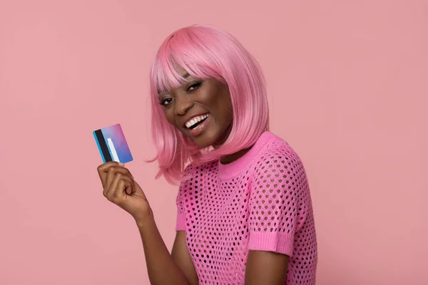 stock image Happy fashion model with pink hairs and credit card on pink background.