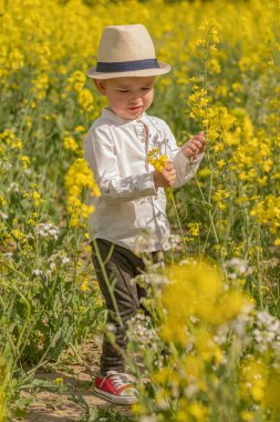 Köyde şık giyinmiş küçük bir çocuk var..