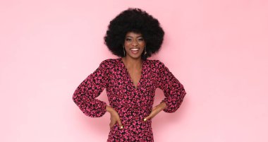 Pretty black woman in a floral dress on a pink background. clipart
