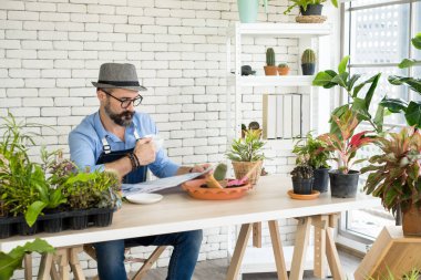 Bıyıklı, yaşlı ve yakışıklı bir adam ağaç bakımıyla mutlu olur. Evde bahçıvanlık hobisi. Emeklilikten sonra mutlu yaşamak. Doğa ve çevre kavramları.
