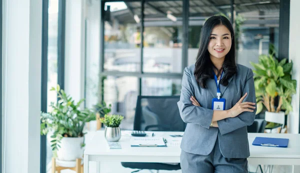 stock image Asian woman entrepreneur with business success standing happily smiling in the office.