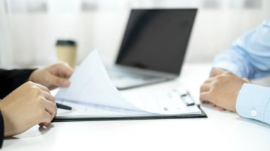 İş kadını İK yöneticileri özgeçmiş tutuyor ve iş görüşmeleri için iş başvuruları ve şirketteki kişisel geçmişleri hakkında konuşuyorlar. İstihdam ve İstihdam kavramları.