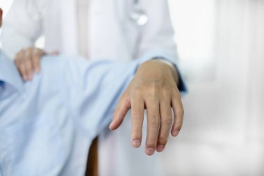 Kadın fizyoterapistler, erkek hastalara omuz sakatlığı olan hastalar için rehabilitasyon merkezinde omuzlarına masaj yapıyorlar. Fizyoterapi kavramları.