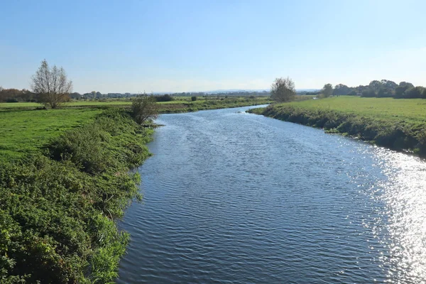 The River Parrett in Langport in Somerset flows slowly through the public path
