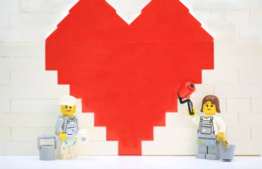 Hong Kong - January 27 2023: workers are working hard to brush the wall and in front of the wall with wall roller 