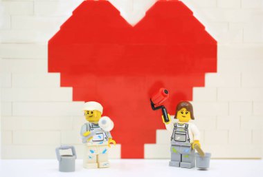 Hong Kong - January 27 2023: workers are working hard to brush the wall and in front of the wall with wall roller 