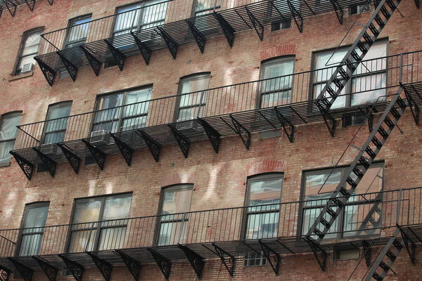 Fire escape ladder in new york low manhattan apartment exterior on the street