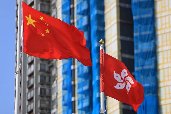 Chinese and hong kong flag set up in the event for celebrating the National Day of the People\'s Republic of China 74 th anniversary with the real estate background