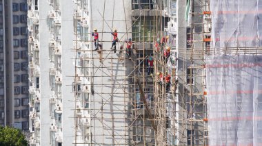 Hong Kong 1 Kasım 2023: İnşaat işçileri bambu iskelesini yerleşim bölgesinde yapıyorlar.