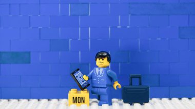 Hong Kong - 15 Şubat 2024: Davası ve telefonu olan bir ofis çocuğu, Pazartesi günü çalışıyor..