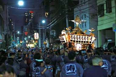 Tokyo - 18 Mayıs 2024: Katılımcılar Sanja Festivali 'nde küçük ölçekli bir türbenin ticaret odalarını temsil ettiği retro sargı giyip tahtırevanı taşıyorlar. Sanja Festivali geleneklerden biri.
