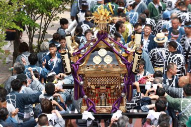 Tokyo- May 12 2024: Motomishima Shrine Grand Festival is take place in Arakawa, Tokyo. The joint procession of portable shrines from each of the clans and town councils passing in front of Shrine clipart