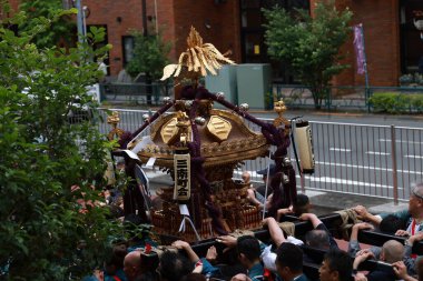 Tokyo- May 12 2024: Motomishima Shrine Grand Festival is take place in Arakawa, Tokyo. The joint procession of portable shrines from each of the clans and town councils passing in front of Shrine clipart