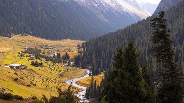 autumn view of Altyn Arashan area in Kyrgyzstan and Tien Shan mountain range clipart