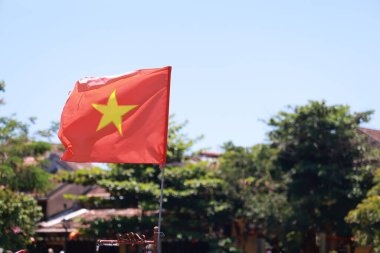 Vietnamese flag in the town of Hoi An clipart