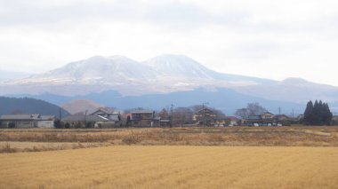 the field near Aso city ,a vast grassy plain with a  great views of the volcanically active Nakadake Peak. clipart