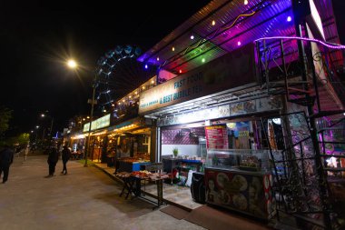 Pokhara, Nepal - November 17 2023: the street food near Phewa lakeside and Pokhara Fun Amusement Park, at weekend night local people will take a walk in Phewa lakeside. clipart