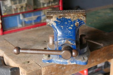 blue iron vice on a workbench