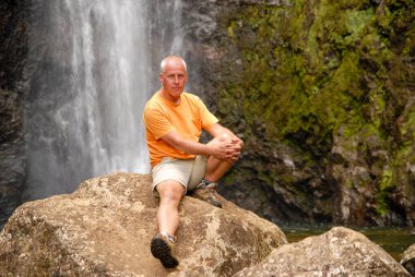 man in front of a waterfall, Ile de la Reunion