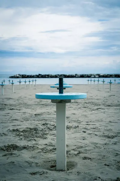 stock image Romagna or Riviera Romagnola beach, off season mood. Before season starts in april or may, or october. Liminal spaces, slight melancholy feeling, uncertain weather, damp sand.