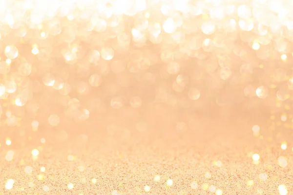 Golden sparkling background with shiny blurred bokeh