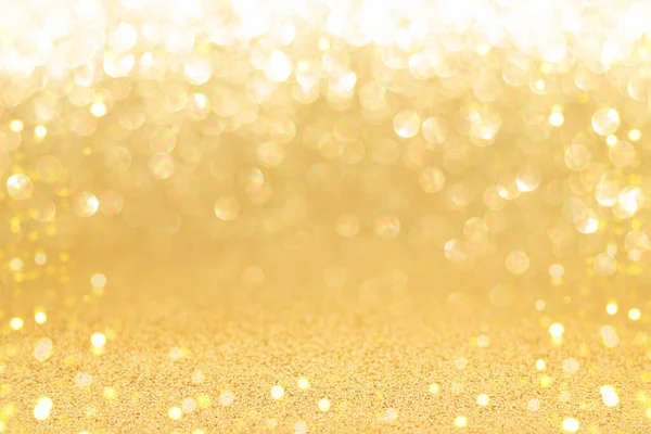Golden sparkling background with shiny blurred bokeh