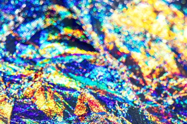 Canlı ışık yansımaları ve benzersiz soyut detaylara sahip renkli holografik doku.