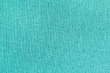 Turkuaz kumaşın pürüzsüz bir bitiş noktasında görünür ipliklerle desenli yakın çekimi