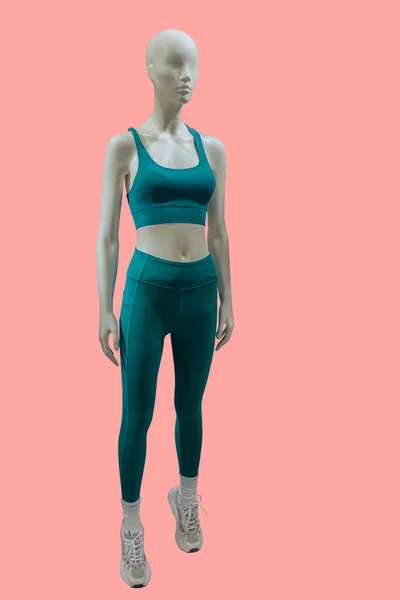 ピンクの背景に隔離されたスポーツウェアを身に着けている女性ディスプレイマネキンの完全な長さの画像 — ストック写真