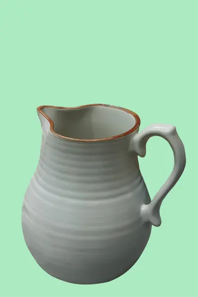 Empty clay jug isolated on a green background, front view