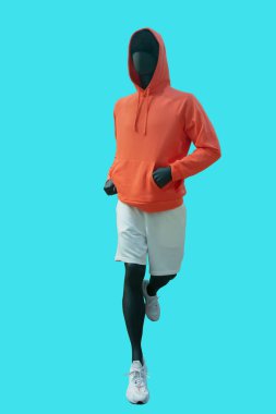 Full length image of a running male display mannequin wearing sportswear isolated on blue background