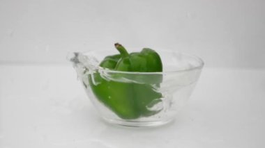 Su kabına düşen yeşil kapsiyum.