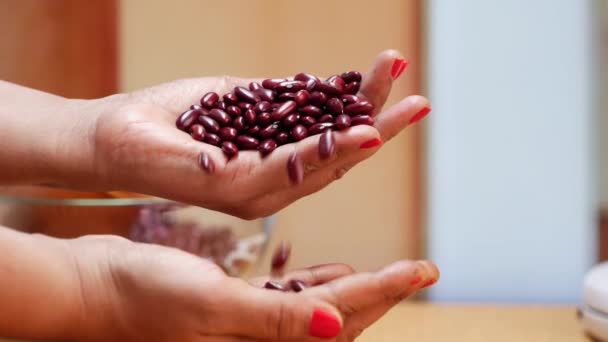 Hand Holds Bowl Red Beans While Woman Holds Handful Them — Stock Video