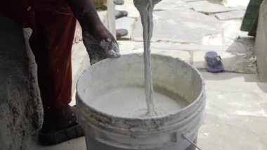 Hand Mixing Cement in a Bucket - A Construction Site Moment