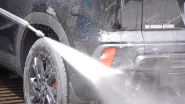 Washing a Hyundai Car in Motion - A Stream of Water and Clean