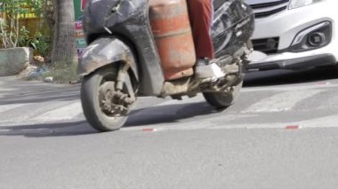 City Traffic - A Close-up of a Motorcycle and Car Intersection