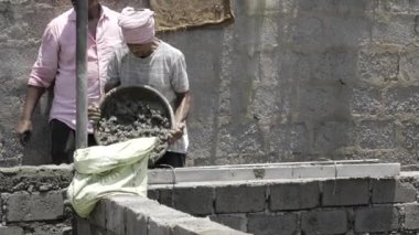 Efficient Cement Mixing - Skilled Labor at Construction Site