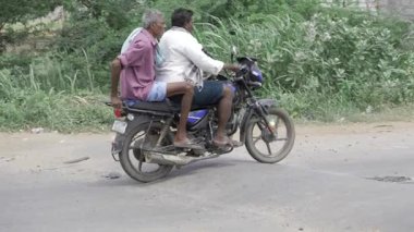 Friendship and Thrill - Three Friends Share a Motorcycle Moment