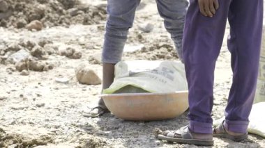 Preparing Cement Mix - A Dusty Task in Progress