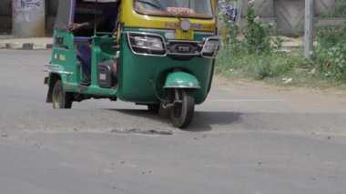 Energetic City Ride on a Green Motorcycle Taxi